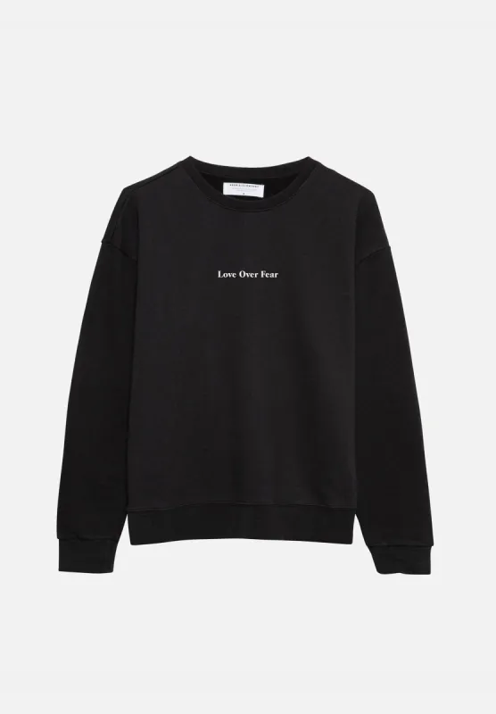 Black 'Love Over Fear' Essential Sweatshirt sold by Seek Discomfort