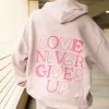 NEW! | "LOVE NEVER GIVES UP" PREMIUM HOODIE sold by He Would Love First