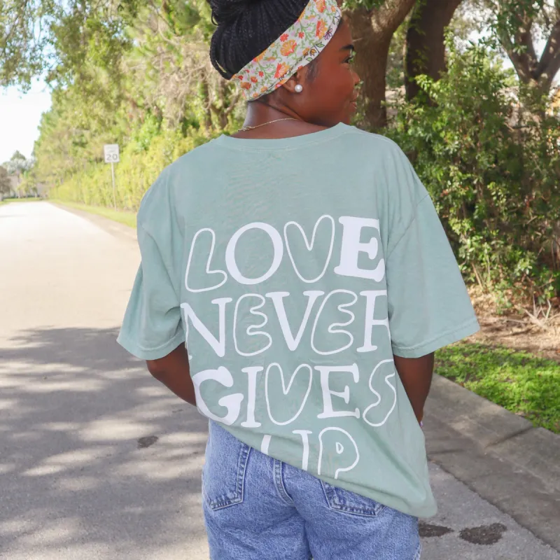 NEW! | "LOVE NEVER GIVES UP" PREMIUM COMFORT COLOR TEE | BAY sold by He Would Love First