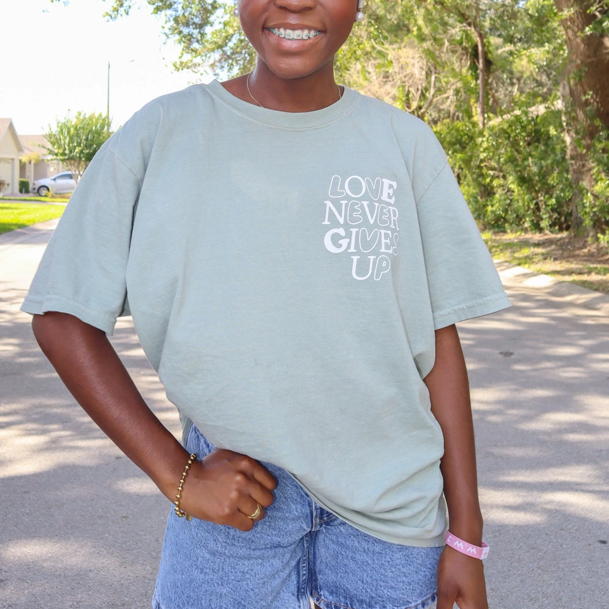 NEW! | "LOVE NEVER GIVES UP" PREMIUM COMFORT COLOR TEE | BAY sold by He Would Love First product image thumbnail 2