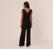 Sleeveless Smocked Jumpsuit With V-Neckline In Black sold by Adrianna Papell
