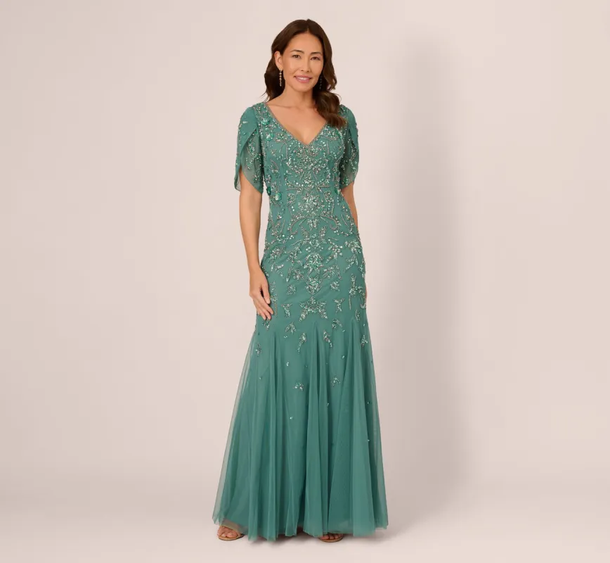 Beaded Mermaid Gown With Sheer Petal Sleeves In Green Slate sold by Adrianna Papell