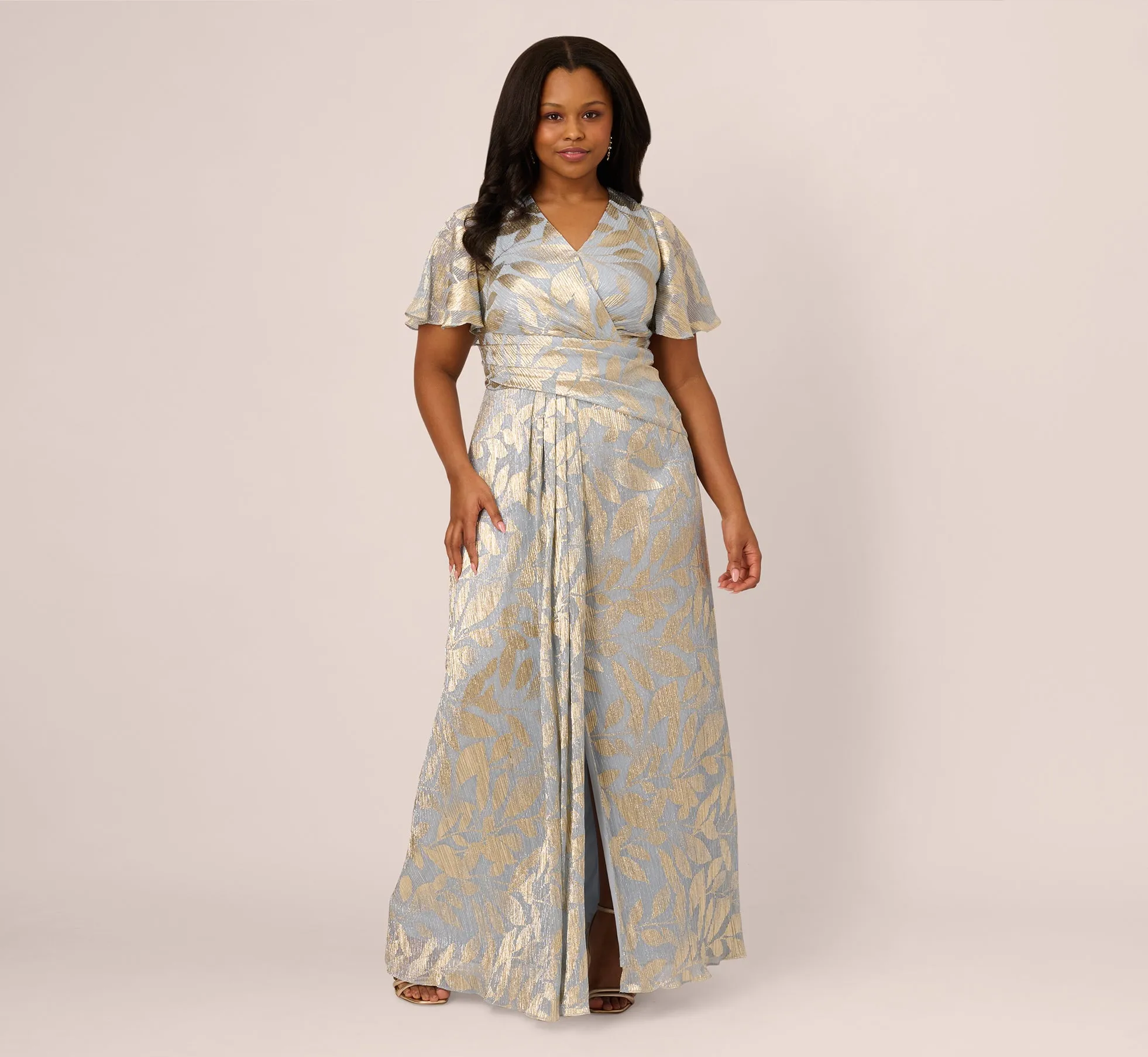 Plus Size Foil Leaf Short Sleeve Gown With Draped Details In Light Blue Gold sold by Adrianna Papell