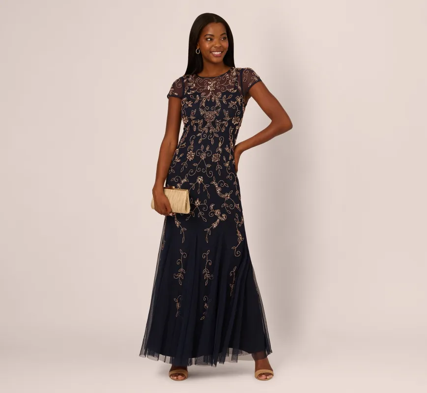 Floral Beaded Godet Gown With Sheer Neck And Short Sleeves In Navy Rosegold sold by Adrianna Papell