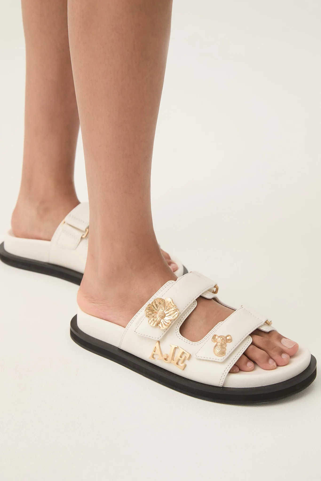 Augustine Charm Slide sold by Aje