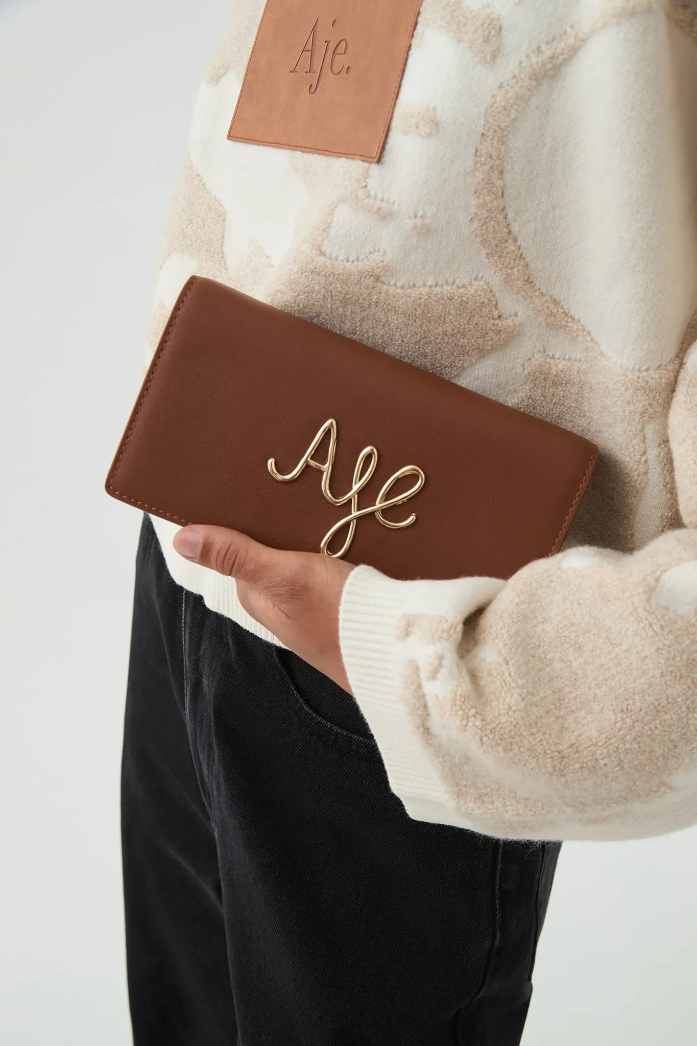 Joni Logo Chain Clutch sold by Aje