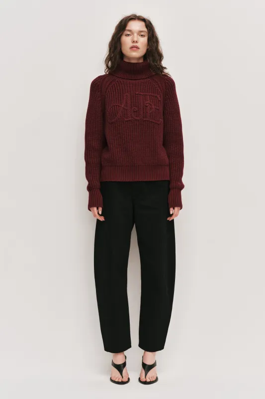 Mea Logo Funnel Neck Jumper made by Aje