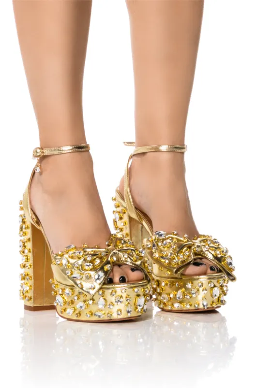 AZALEA WANG MAYA EMBELLISHED BOW CHUNKY SANDAL IN GOLD sold by AKIRA