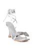 AZALEA WANG APATE EMBELLISHED BOW SANDAL IN SILVER sold by AKIRA