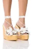 BLOOMY FLOWER LACE UP WEDGE SANDAL IN WHITE sold by AKIRA