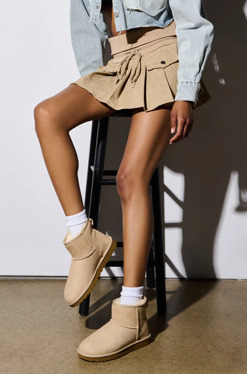 UGG CLASSIC SAND MINI sold by AKIRA