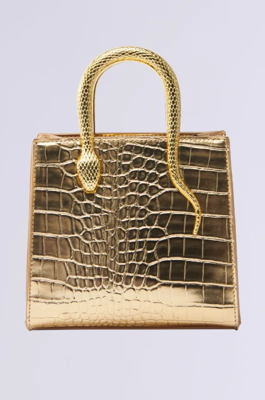 SNAKIN THRU LIFE GOLD CHROME PURSE sold by AKIRA