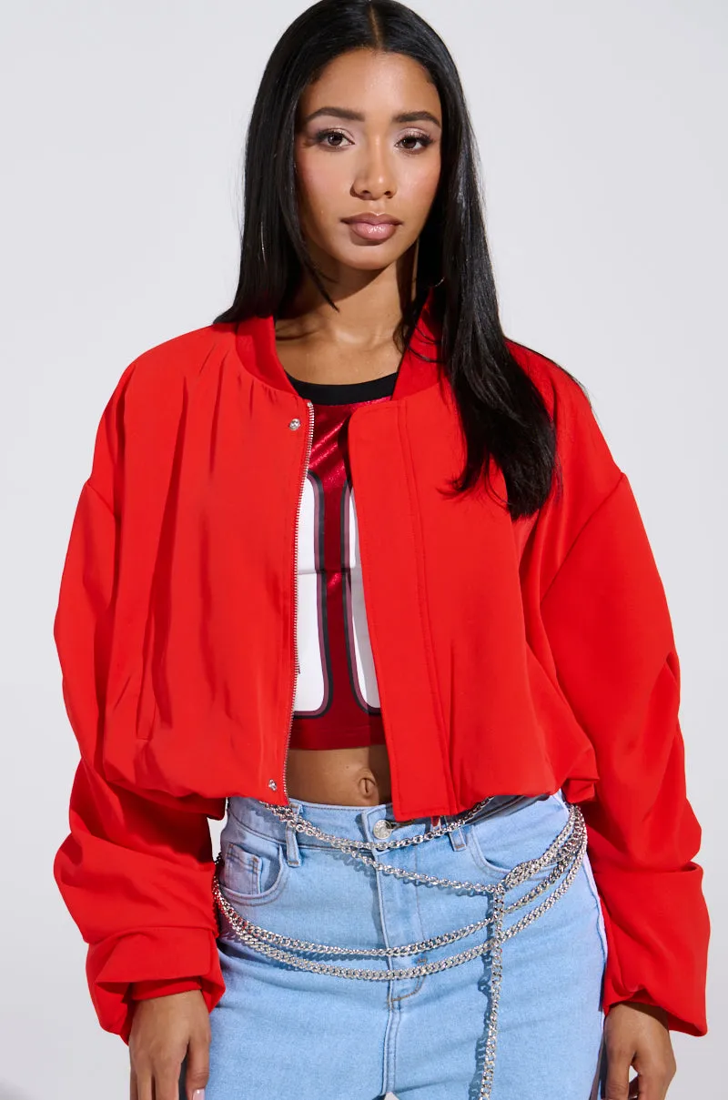TREY RUCHED SLEEVE BOMBER IN RED sold by AKIRA