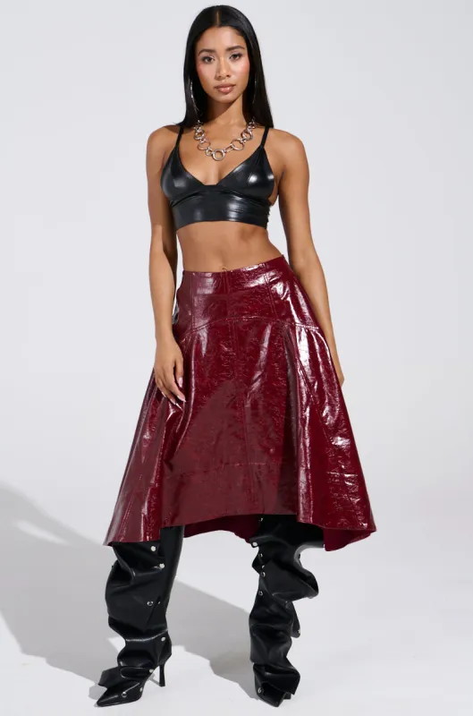THINK ABOUT IT FAUX LEATHER MIDI SKIRT IN BURGUNDY sold by AKIRA