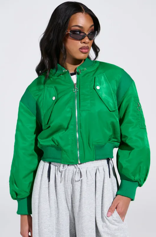 LUCKY ME ASYMMETRICAL BOMBER IN GREEN sold by AKIRA