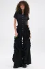 LEAVE IT RUFFLED JUMPSUIT IN BLACK sold by AKIRA
