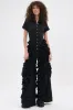 LEAVE IT RUFFLED JUMPSUIT IN BLACK sold by AKIRA