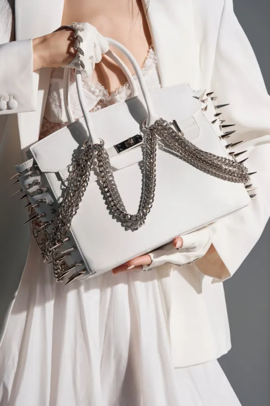 STAY BLESSED SPIKE PURSE sold by AKIRA