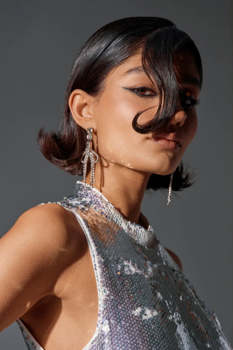 WITH A BOW SILVER EARRING sold by AKIRA