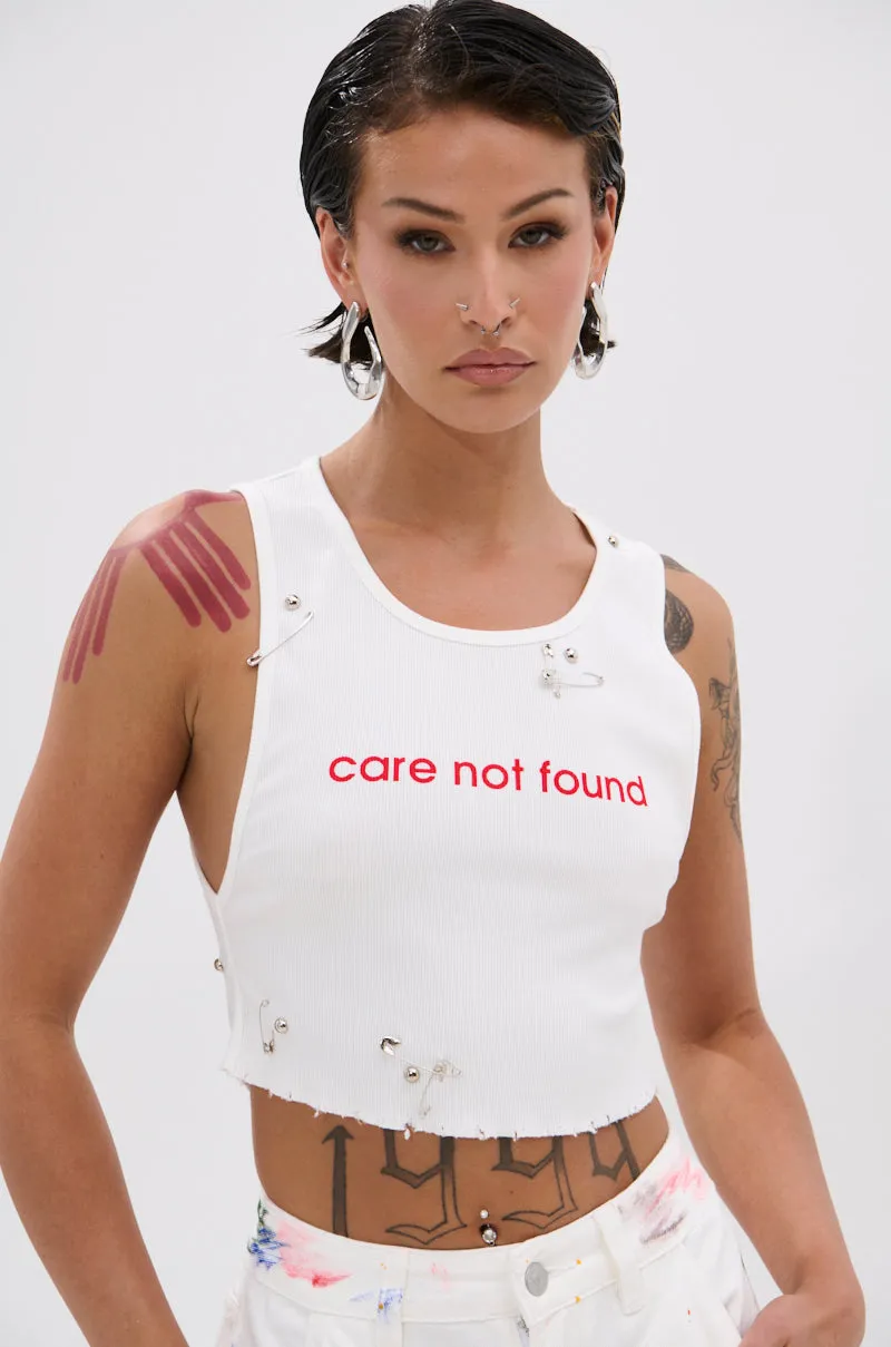 NEVER CARED DISTRESSED CROPPED TANK TOP sold by AKIRA