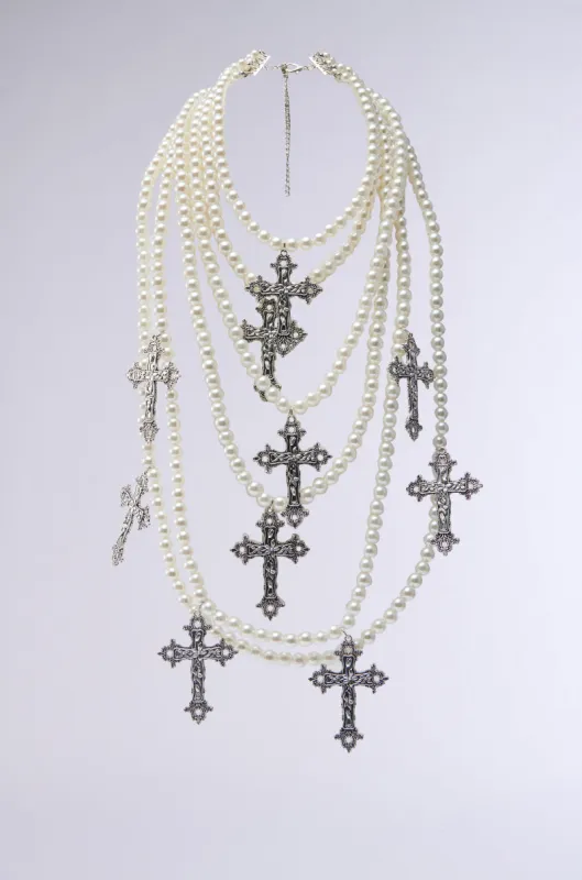 PROTECTED LAYERED CROSS NECKLACE sold by AKIRA