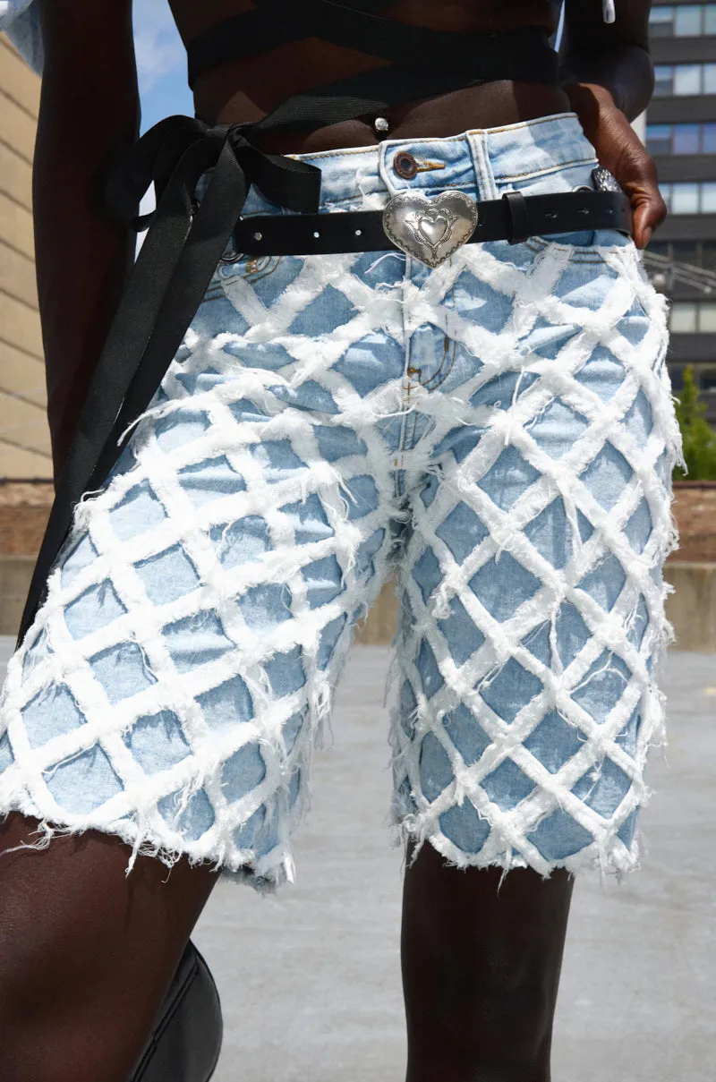 DISTRESSED AND STRESSED DENIM BERMUDA SHORT sold by AKIRA