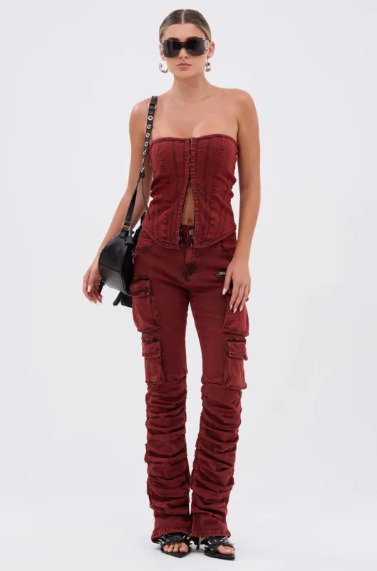 IT GETS EASIER STACKED CARGO PANT IN BURGUNDY sold by AKIRA