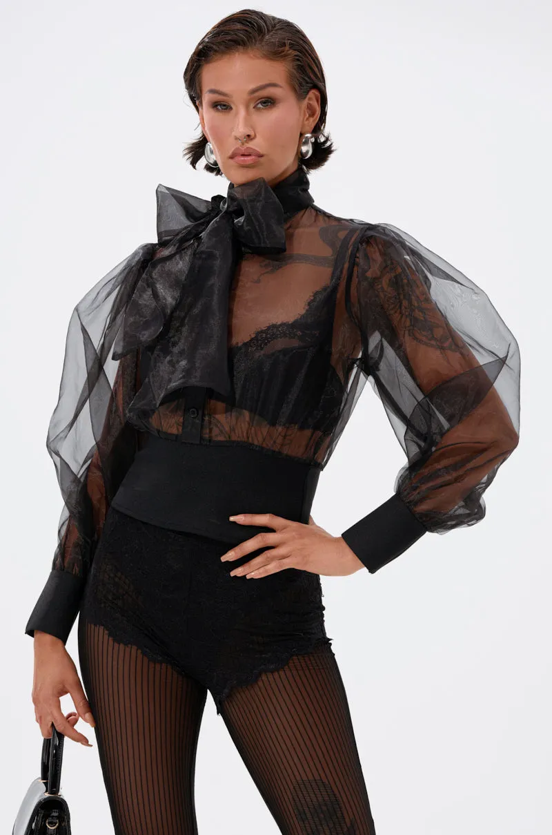 DANCE AND SHAKE BLOUSE WITH BOW IN BLACK sold by AKIRA