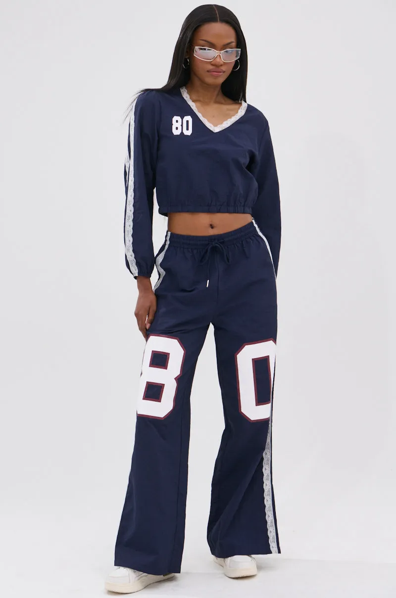 LACE TRIM NYLON TRACK PANT sold by AKIRA