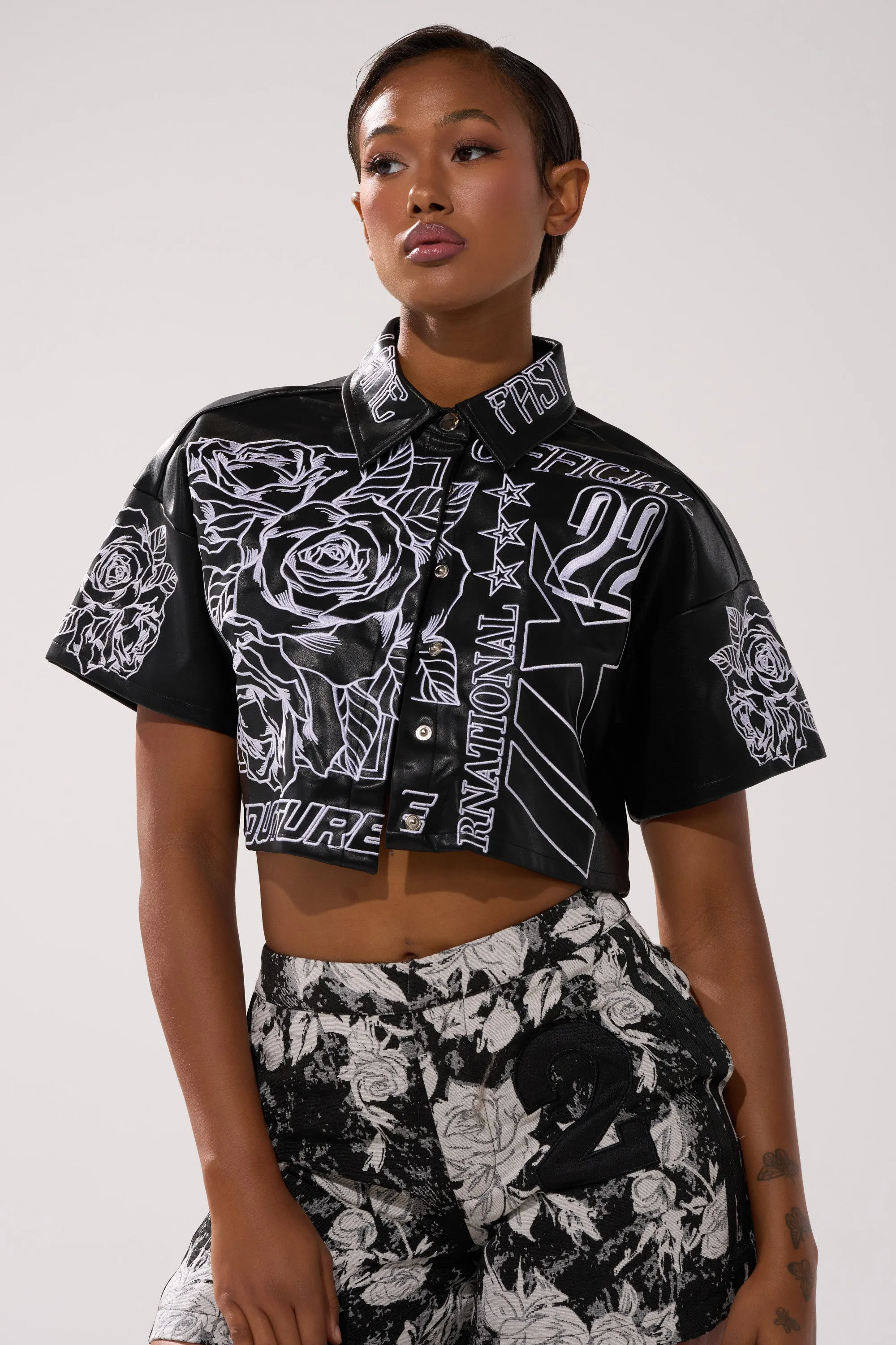 MAKE IT OFFICIAL FAUX LEATHER BUTTON DOWN IN BLACK sold by AKIRA