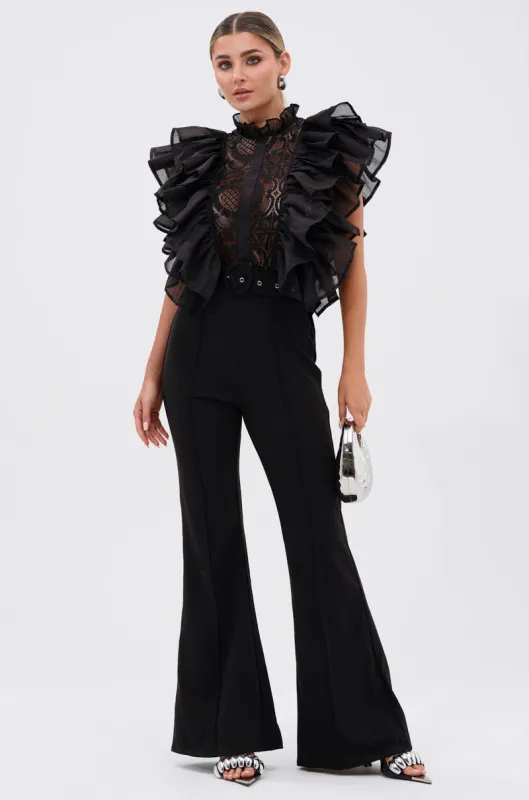 WALK THAT WALK RUFFLE JUMPSUIT IN BLACK sold by AKIRA