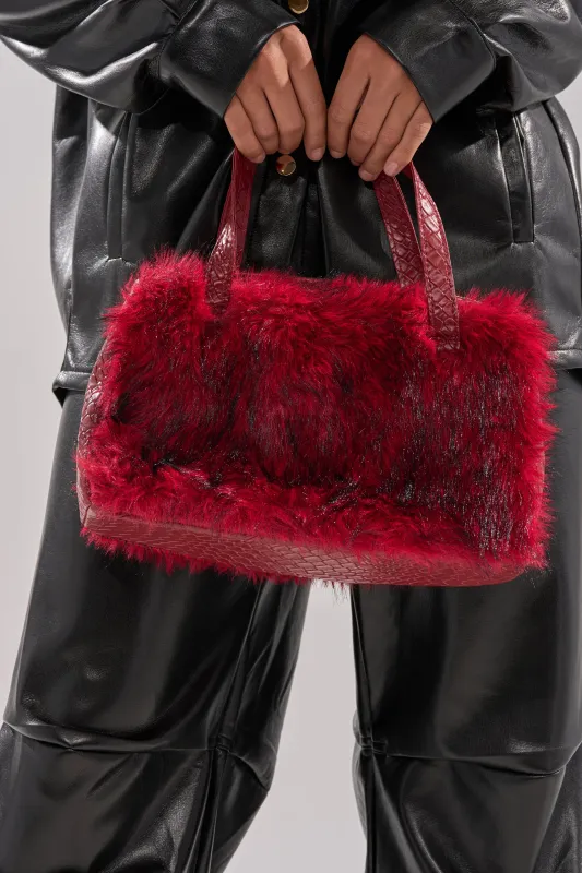 TRUDY FAUX FUR PURSE sold by AKIRA