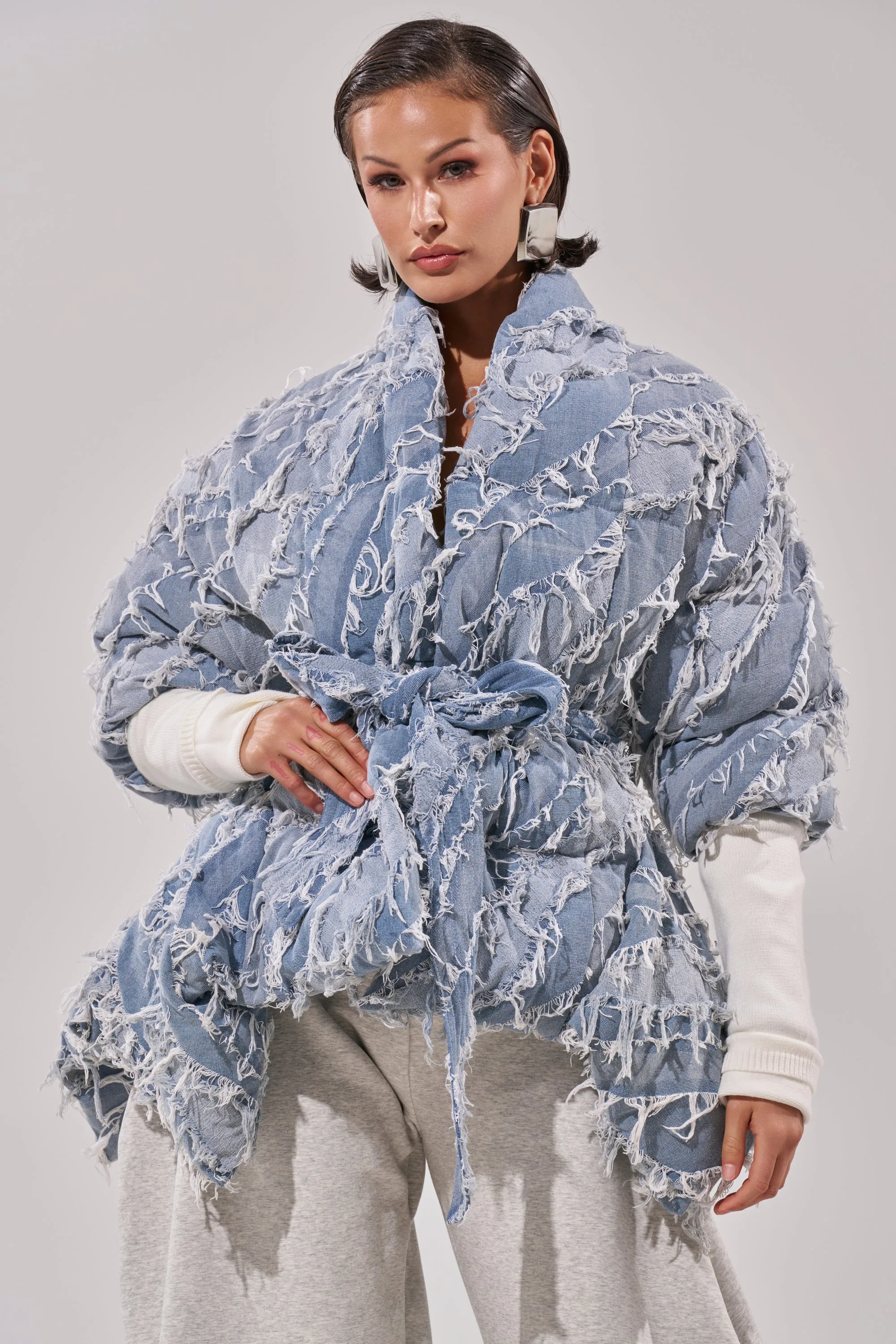 RIB SLEEVE PEPLUM PUFFER IN DENIM sold by AKIRA