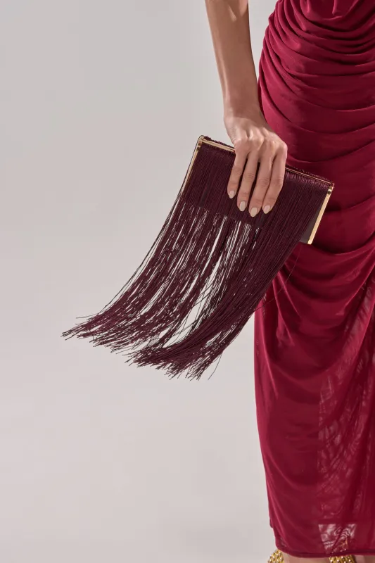 IN THE FRINGE CLUTCH sold by AKIRA