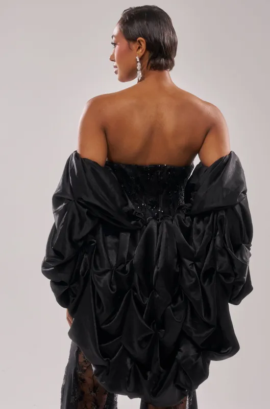 MORE THAN ENOUGH SATIN SHRUG IN BLACK sold by AKIRA