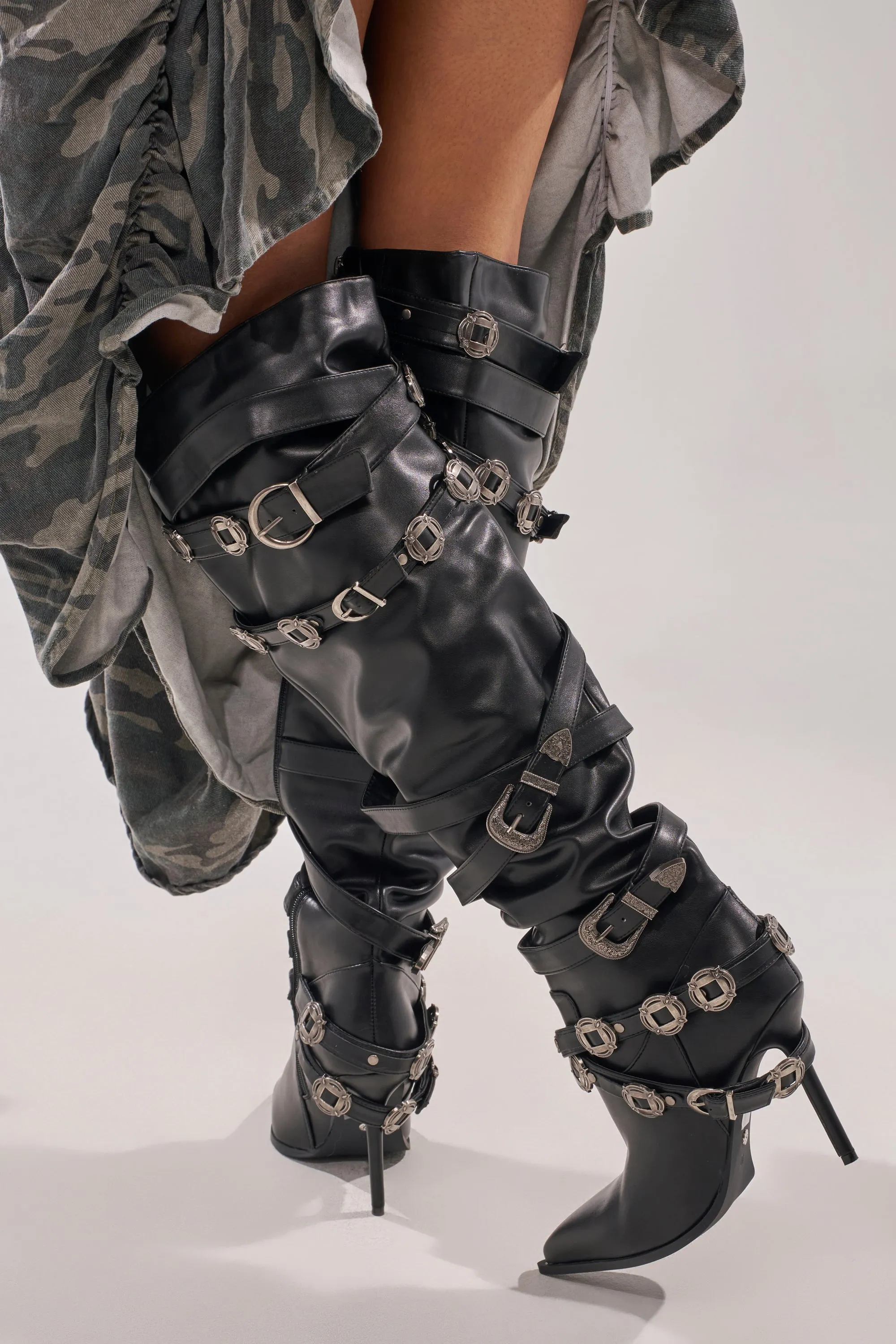 AKIRA GOLD XERXES BLACK STILETTO METAL EMBELLISHED BOOT sold by AKIRA