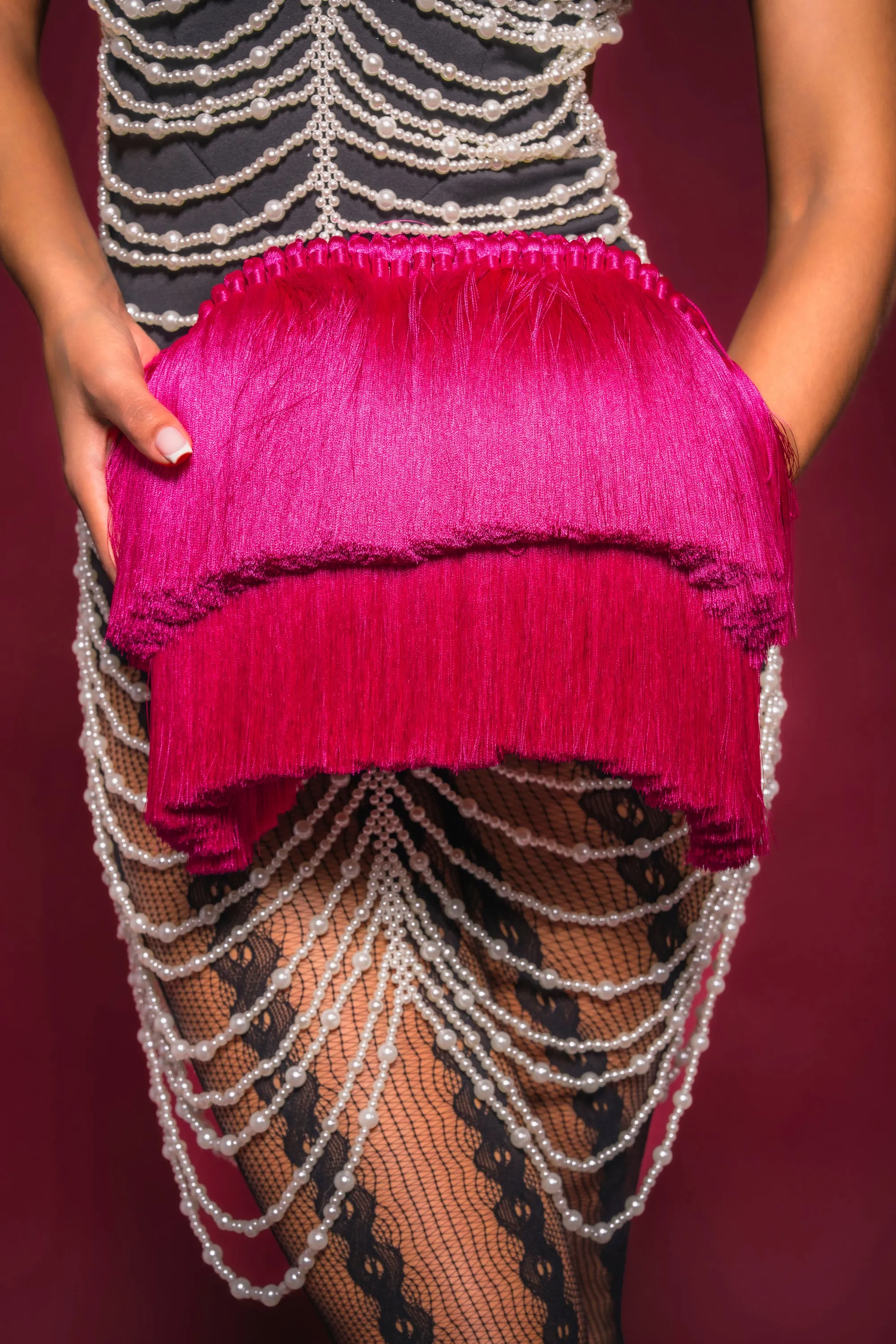 RAZZLE DAZZLE TASSEL CLUTCH sold by AKIRA
