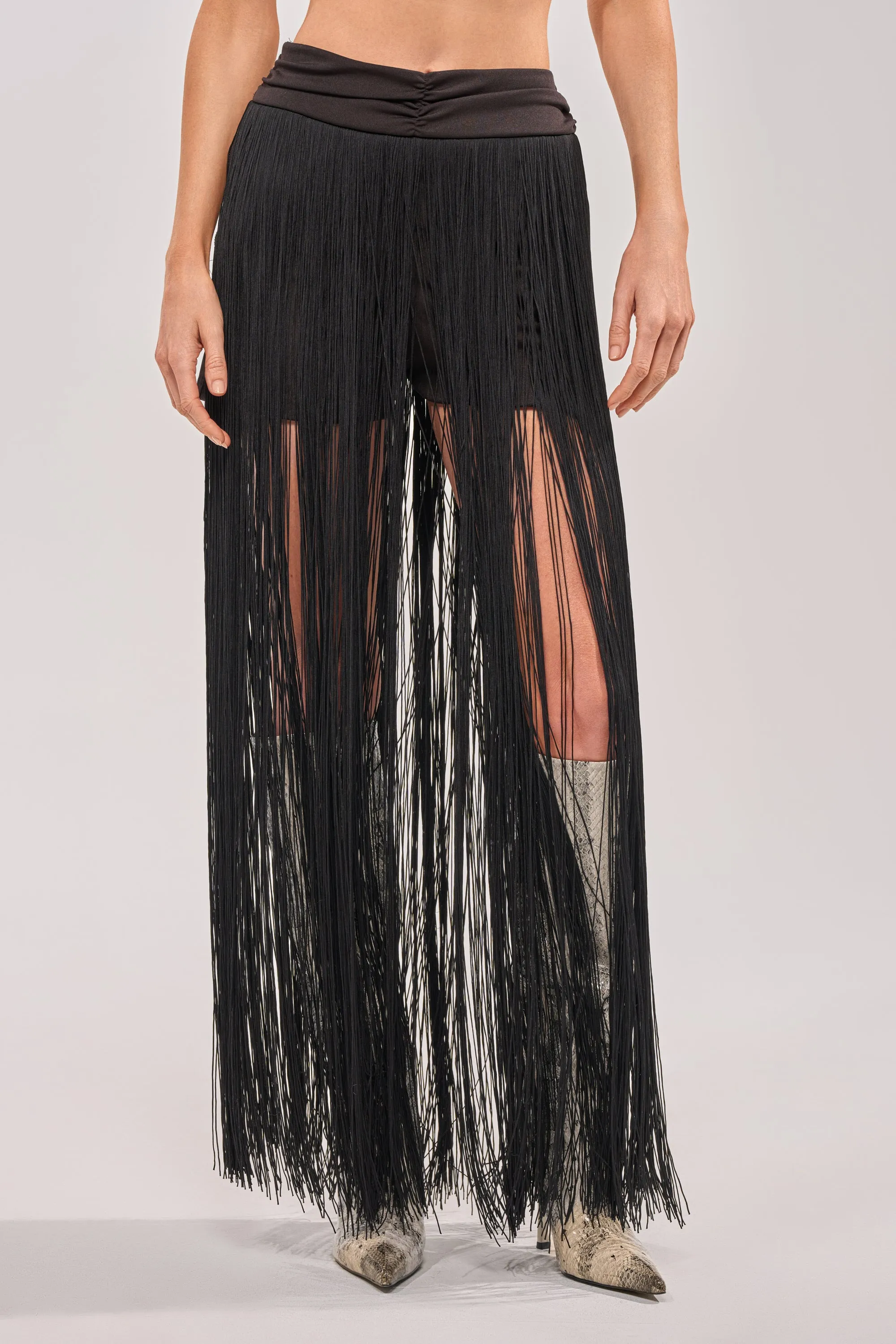 ON THE EDGE FRINGE SKIRT IN BLACK sold by AKIRA