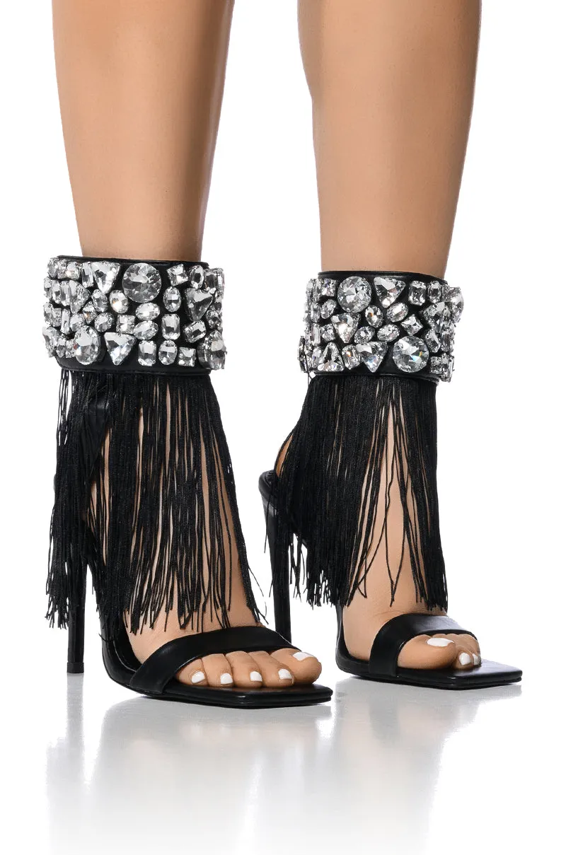 AZALEA WANG NEAVE EMBELLISHED TASSEL SANDAL IN BLACK sold by AKIRA