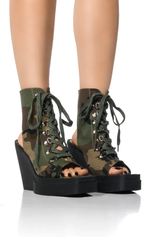 OFF DUTY PEEP TOE BOOTIE IN CAMO sold by AKIRA