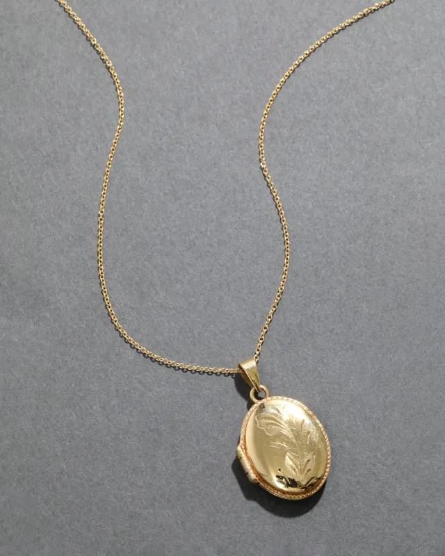 Vintage 1940s 14k Gold Hand Etched Floral Oval Locket Necklace sold by Alexis Bittar