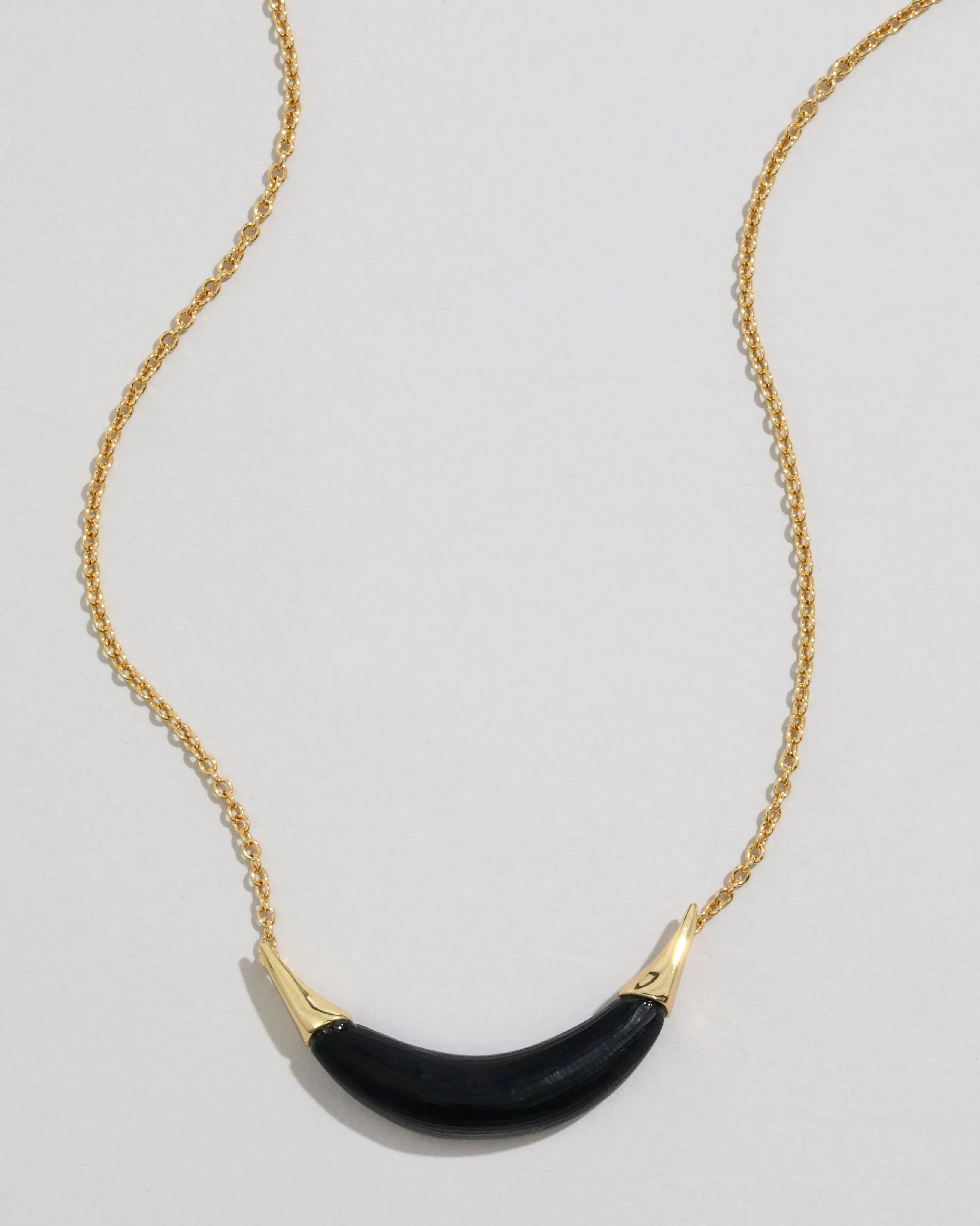 Gold Capped Crescent Lucite Necklace- Black sold by Alexis Bittar