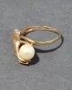 Vintage 1940s 14k Gold Hand Ring Motif Ring with Cultured Pearl & Diamond sold by Alexis Bittar