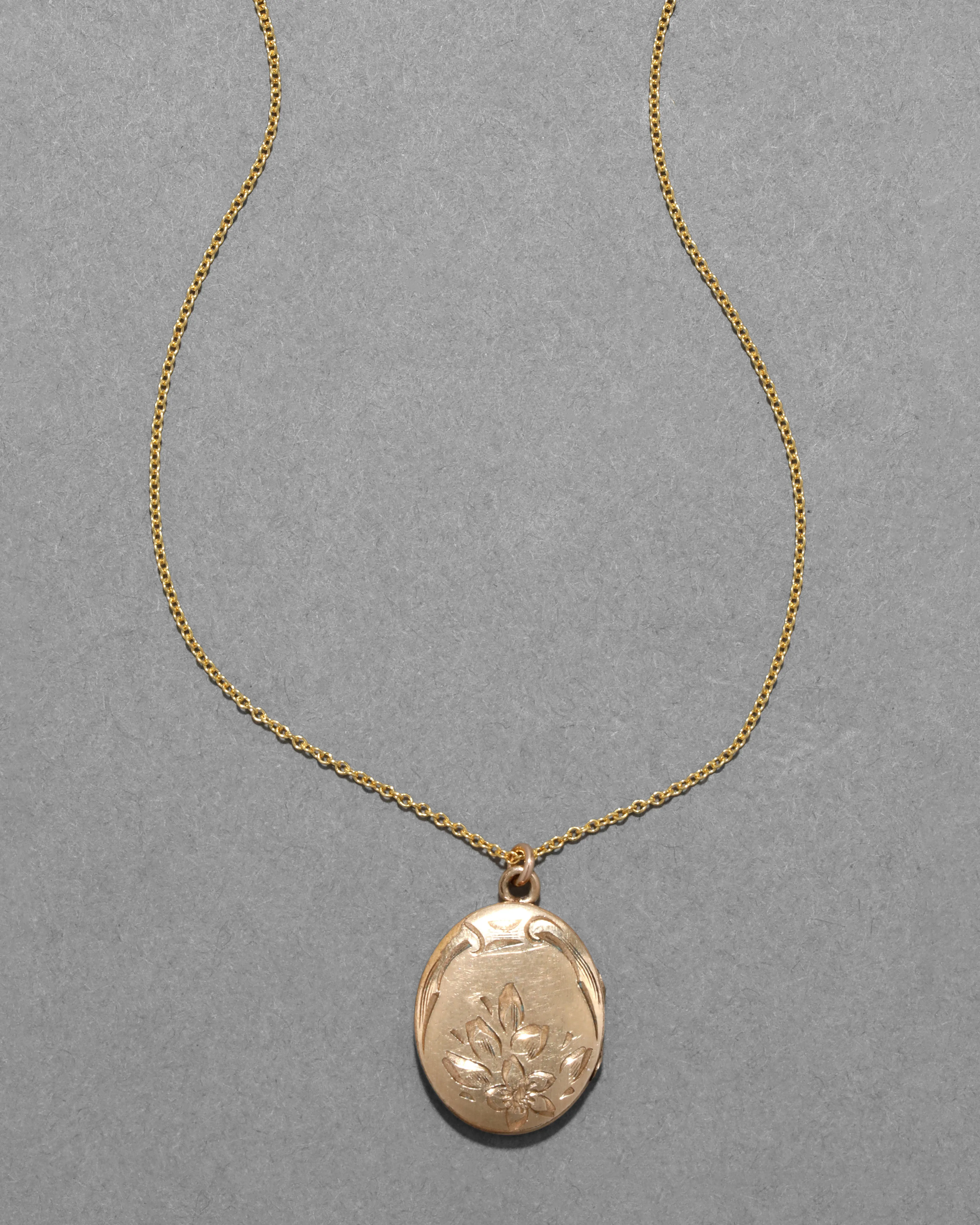 Vintage 1930s 14k Gold Filled Etched Floral Design Oval Locket Necklace sold by Alexis Bittar