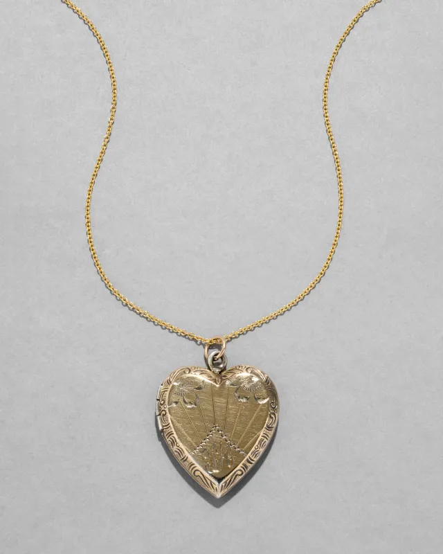 Antique 1920s 14k Gold FiIled Engraved Sunburst Heart Locket Necklace sold by Alexis Bittar