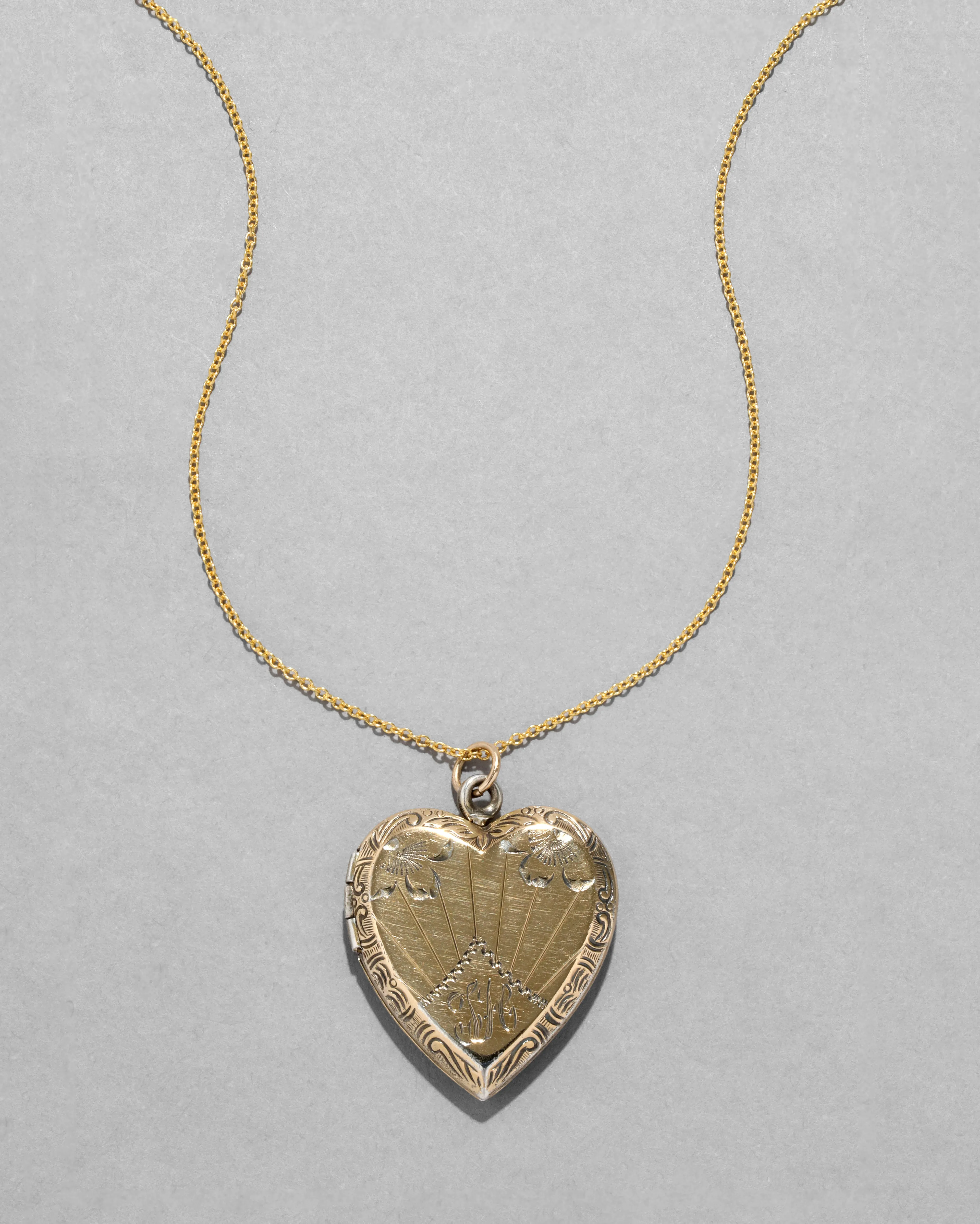 Antique 1920s 14k Gold FiIled Engraved Sunburst Heart Locket Necklace sold by Alexis Bittar