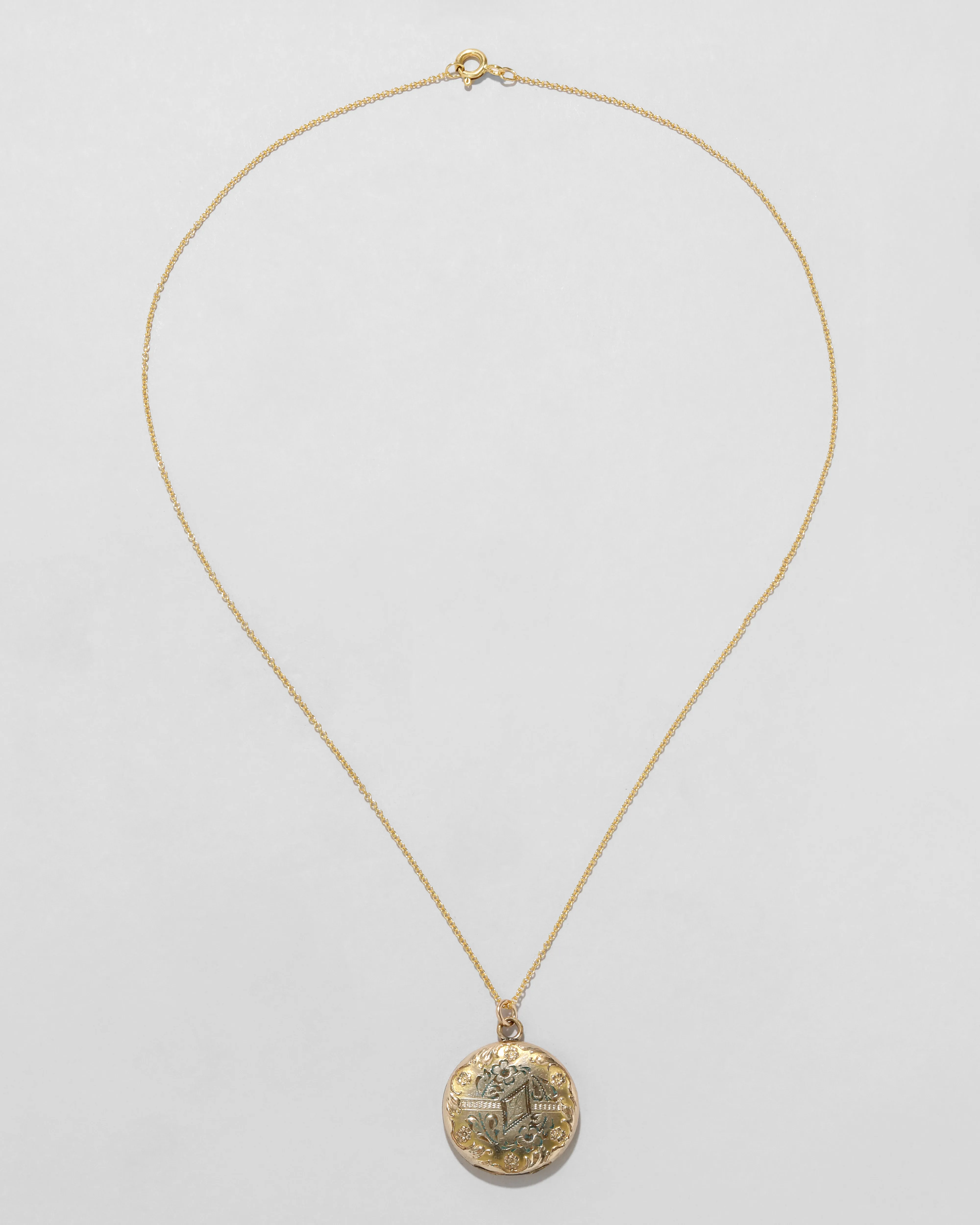 Antique 1880s 14k Gold Filled Etched Ornate Repousse Border Circle Locket Necklace sold by Alexis Bittar