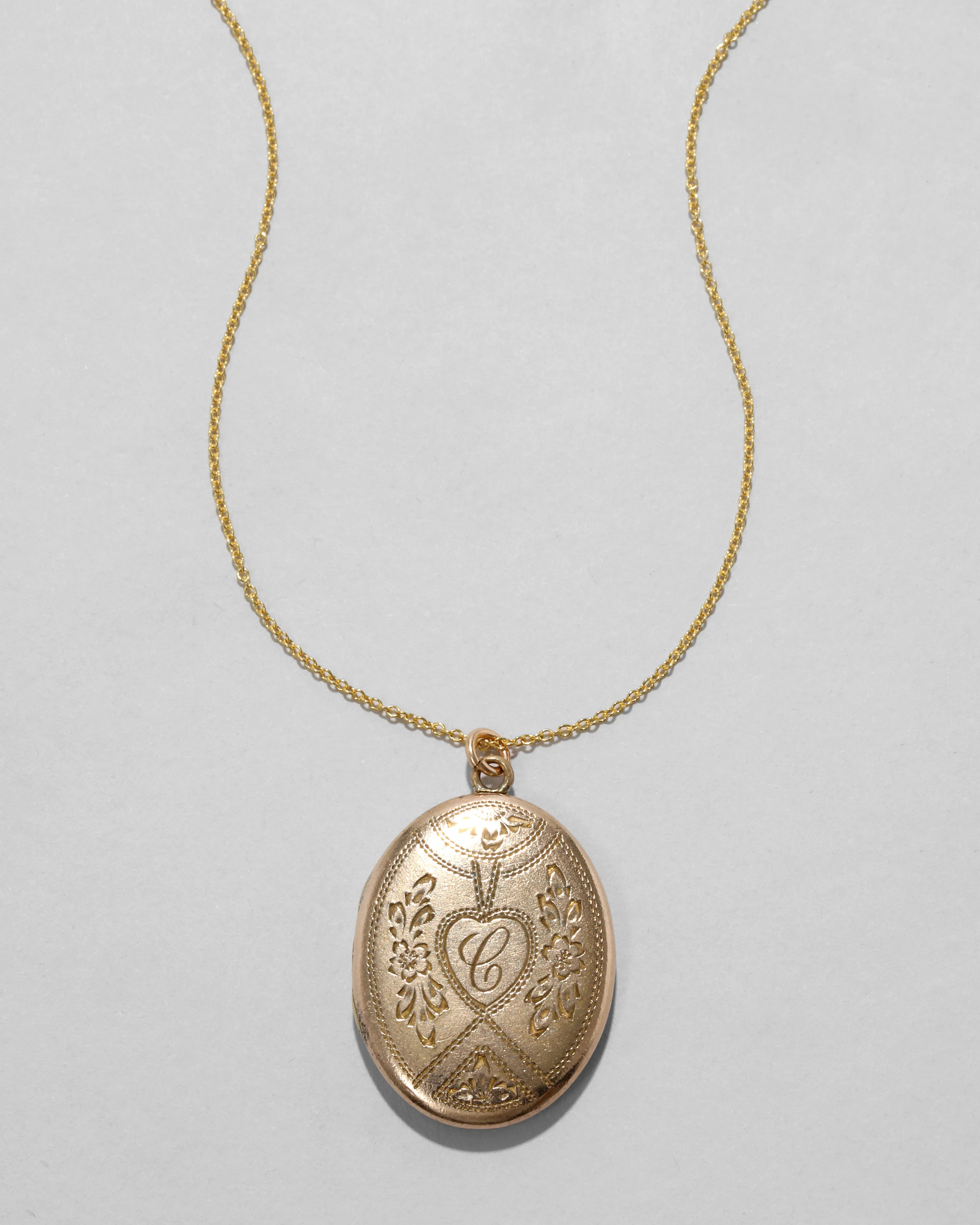Antique 1880s 12k Gold Filled Floral & Heart Etched Oval Locket Necklace sold by Alexis Bittar
