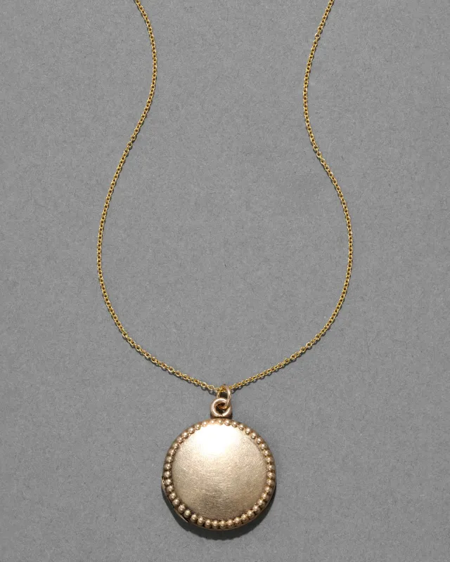 Antique 1920s Gold Filled Beaded Border Circle Locket Necklace sold by Alexis Bittar