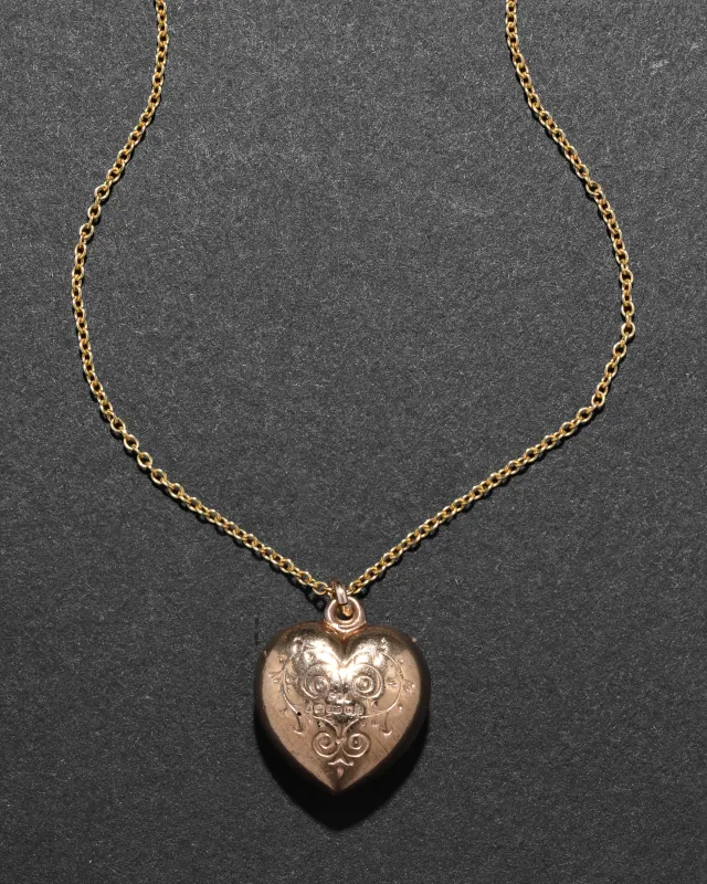 Antique 1920s 9k Gold Etched Double Sided Puffy Heart Necklace sold by Alexis Bittar
